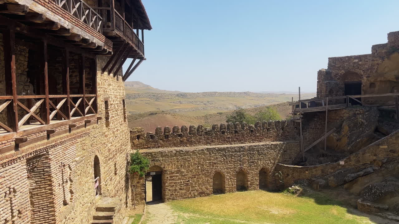 Static shot of David Gareji monastery balcony and walls in Georgia, with blue skies and peaceful vibes in a beautiful summer day