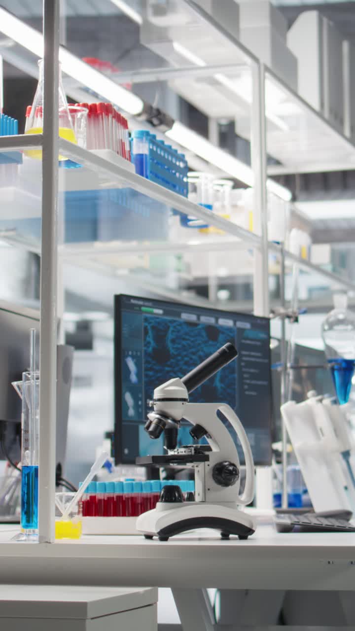 Vertical video Computer in biotechnology laboratory showing molecular model and microscope