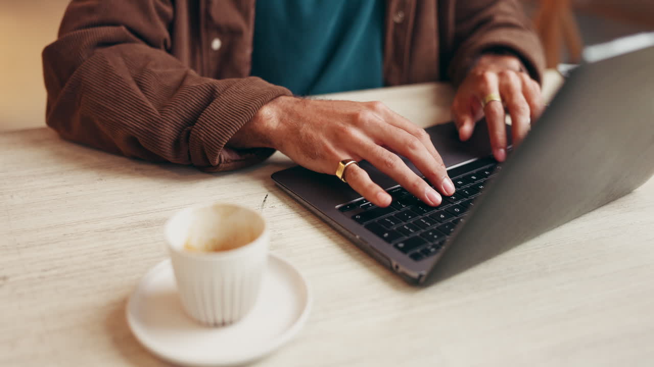 Typing on a Laptop with Coffee