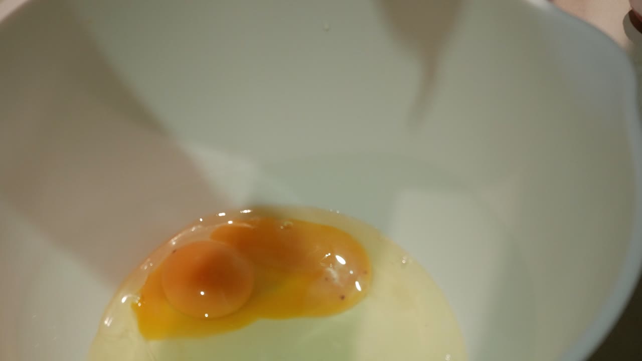 Egg and vanilla in mixing bowl for baking, simple and calm atmosphere