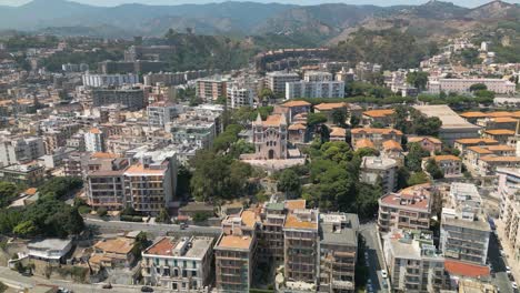 establishing shot of picturesque cathedral overlooking messina, sicily, italy