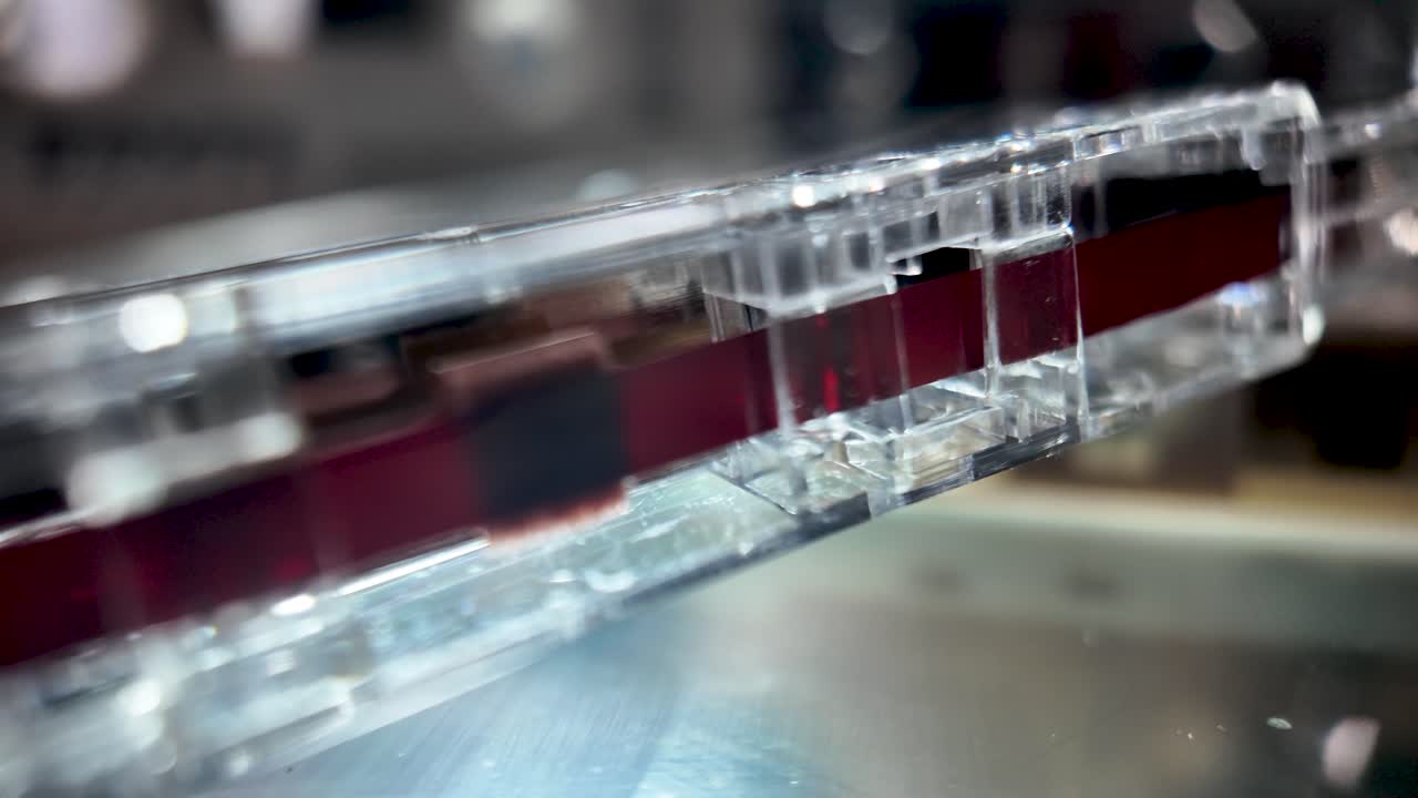 Close up of a vintage audio cassette tape showing its exposed magnetic film