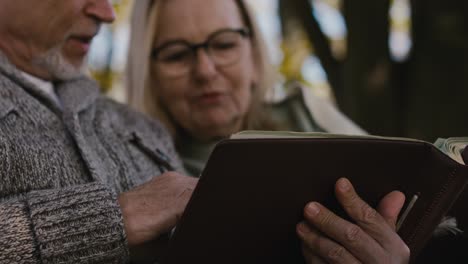 Senior-caucasian-couple-looking-at-old-photo-album