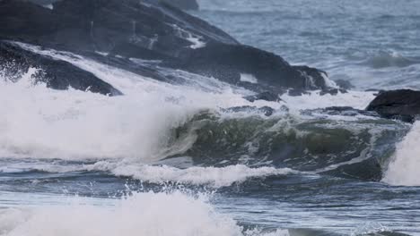 dynamic ocean waves crash against rocky shores at charlesworth bay, coffs harbour. captured in natural light, showcasing powerful sea movement