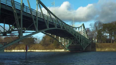 Oskara-Kalpaka-Metal-Swing-Bridge-at-Liepaja-shoot-from-Karosta-canal-bank-in-sunny-afternoon,-wide-shot