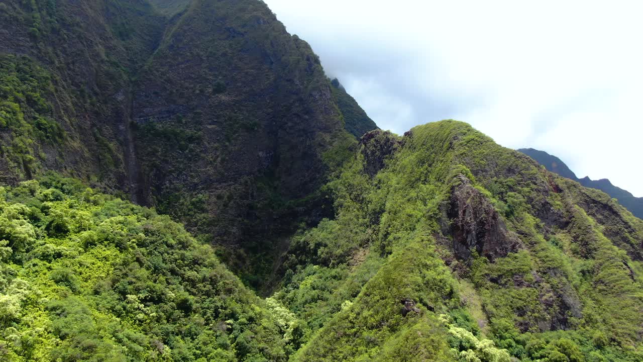 las nubes proyectan grandes sombras sobre el dosel del verde bosque de montaña koolau