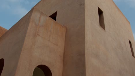 static low angle shot highlighting geometric architecture and sharp lines of building in marrakech, morocco, emphasizing shapes and structure