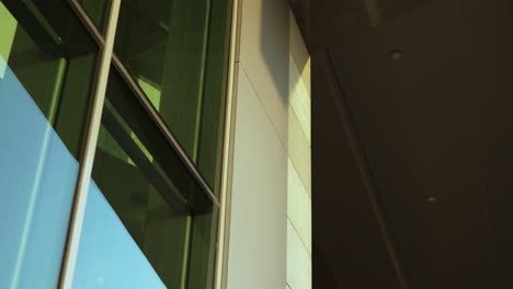 architectural detail of a modern building with reflective windows and angular structures