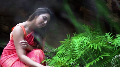 indian woman wearing sari touching fern plants in blue mountains, nsw australia. slow motion shot