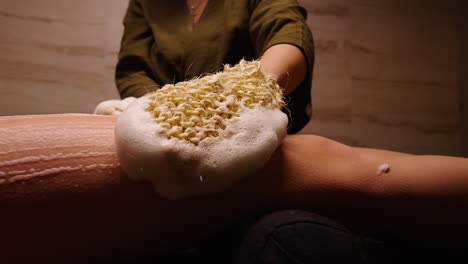 woman getting a body scrub