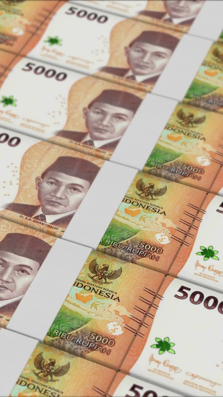 Vertical video of 5000 INDONESIAN RUPIAH banknotes printing by a money press