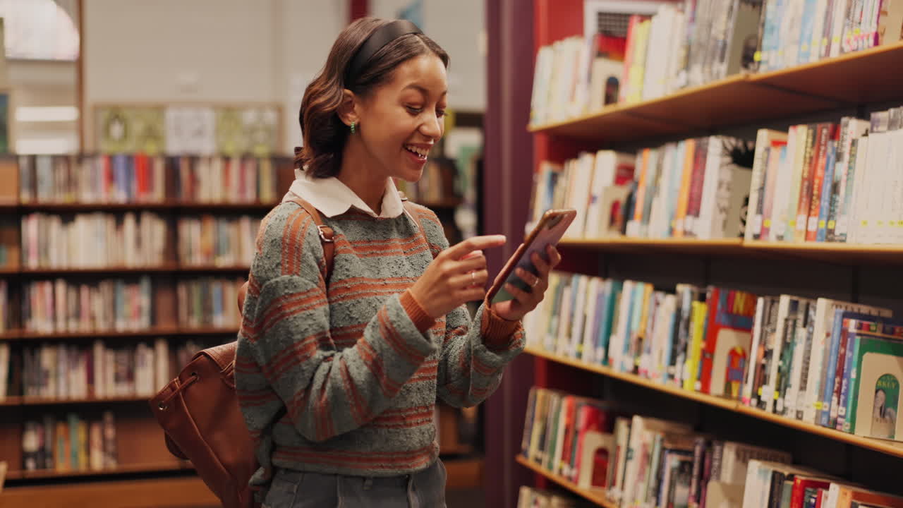 Woman using mobile phone in library