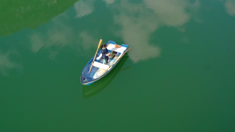 Woman-on-the-boat-catches-a-fish-on-spinning-in-Norway.