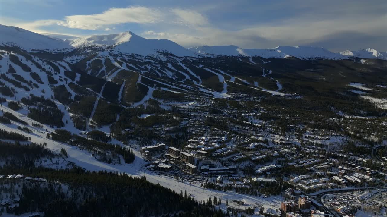 Breckenridge Ski Resort mountain town Colorado aerial drone sunset Winter December January skiing trails run Peak 9 10 Ten Mile Range Epic Vail Pass cirrus clouds chairlifts circle right motion