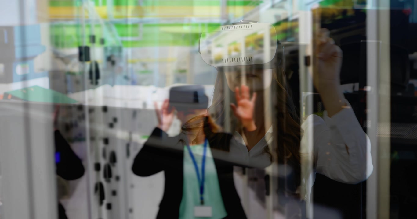 VR-headset woman raising hands to activate virtual server tools, colleague guiding near glass racks