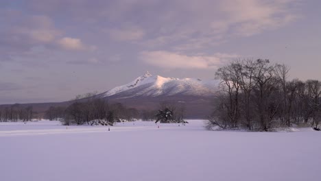 breathtaking view out over frozen lake at onuma koen with mountain in distance