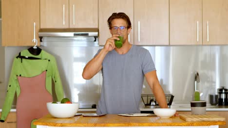 man having healthy drink in kitchen 4k