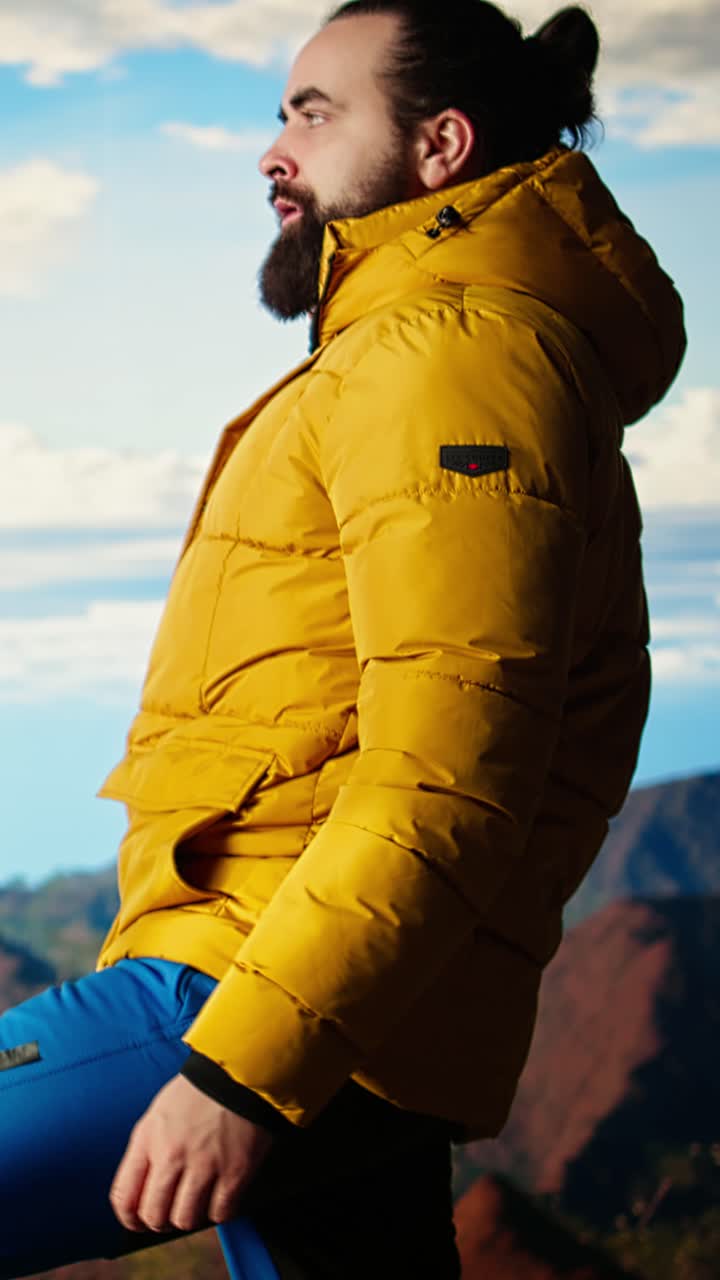 Adventurous Man in Yellow Jacket Posing on Mountain Peak
