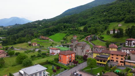 picturesque aerial shot of gaiano showing traditional architecture, football field, and rolling hills. shot in gaiano, italy (gaiano, italia)