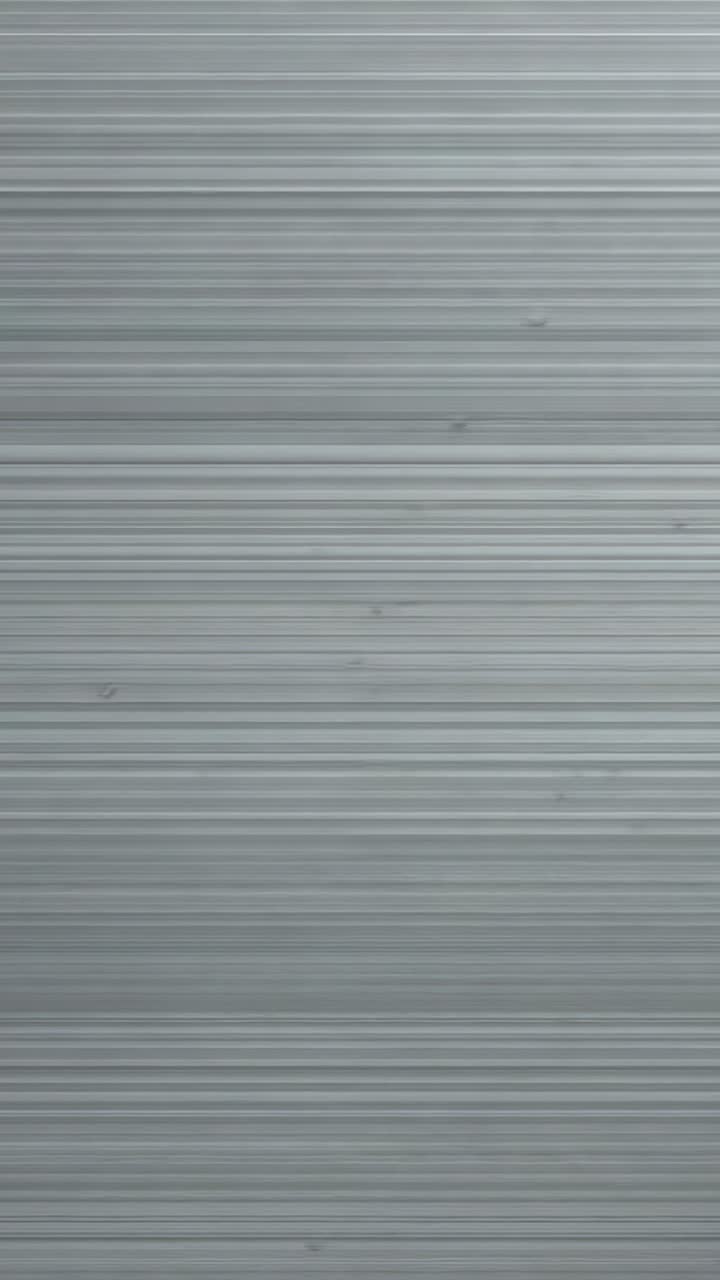 Vertical video: Sliding diagonal shadow revealing ribbed panel closeup, showing fine lines, specks