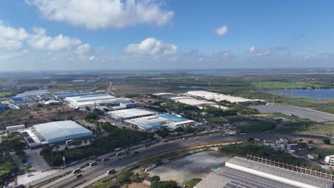 this aerial stock footage captures an expansive view of a large industrial park situated amidst a significant natural landscape on the outskirts of chennai