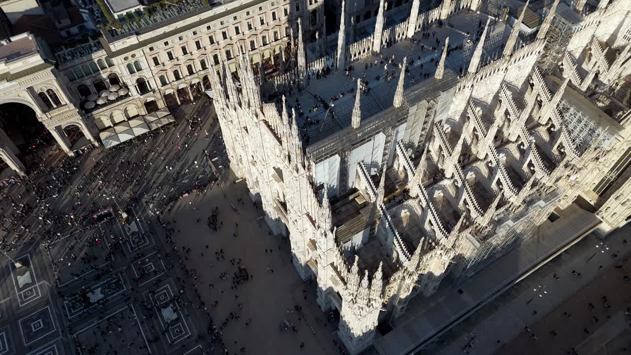 Aerial of Milan old cathedral main square downtown , European capital city drone footage of tourist attraction