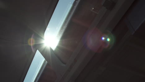 lens flare shining through rooftop of train window