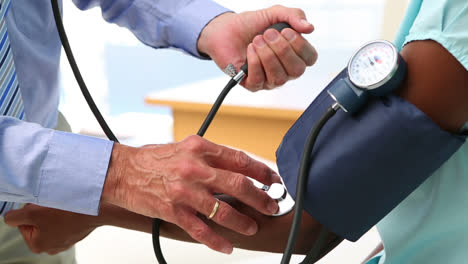 doctor checking the blood pressure of patient