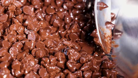 stirring chocolate chips in a metal bowl