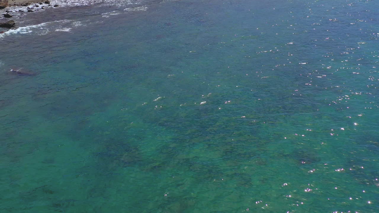 Flying over the beautiful Amadores beach at Gran Canaria – stock footage, Aerial shot of Gran Canaria coast with resort. Flying over calm water.