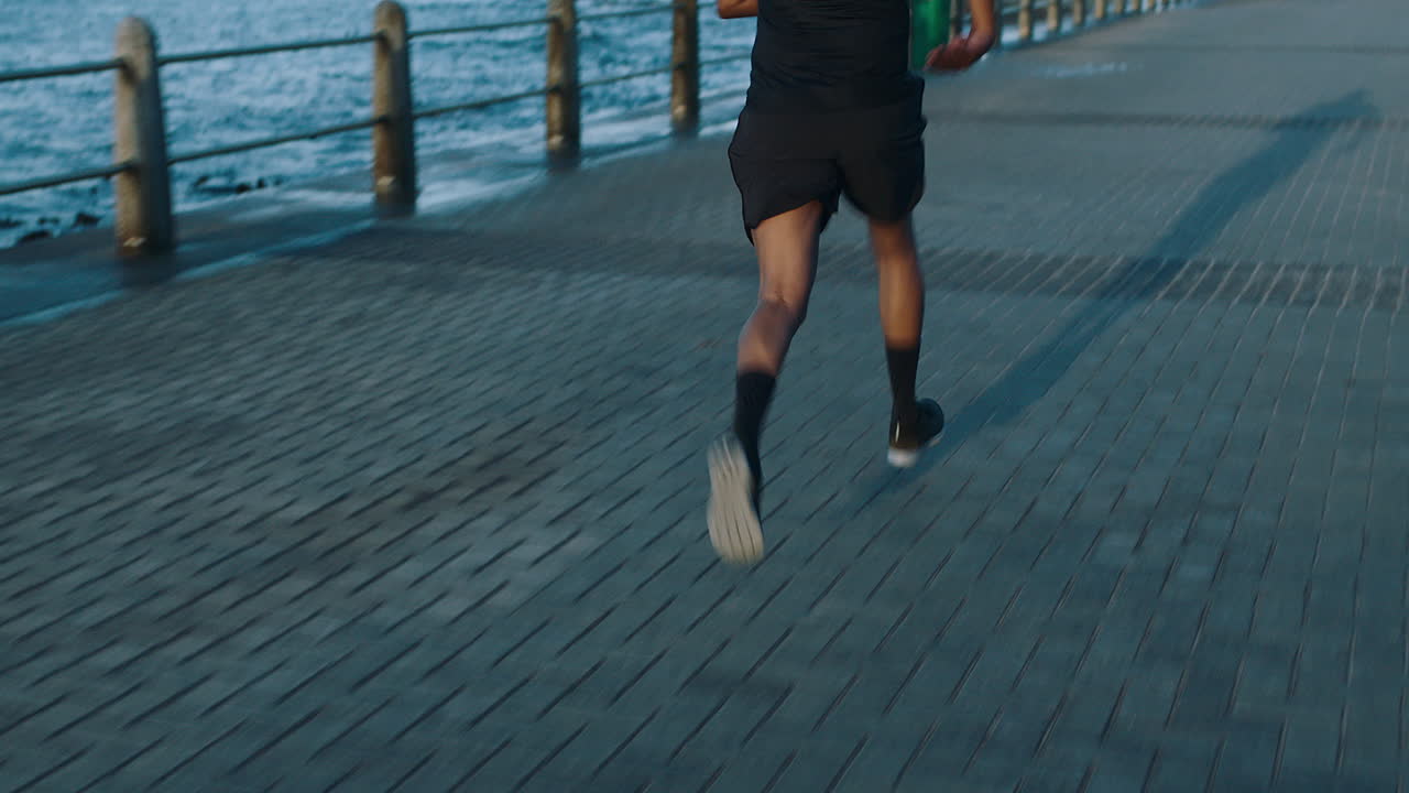 Black man, runner by the beach