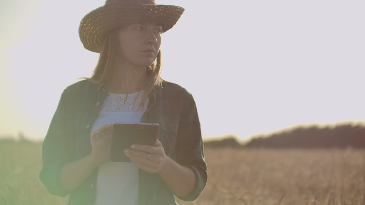 A woman farmer with tablet. Smart farming and digital agriculture.