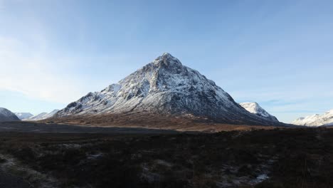 slow tilting shot of the famous buchaille etive mor with a winter coat on