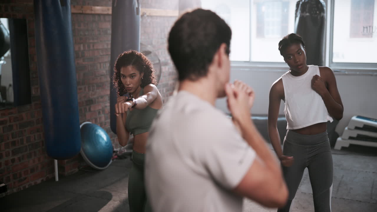 Women boxing in a gym