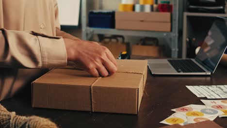 e-commerce storage shop, woman packing goods and clothes for second hand delivery market, dedicated packaging and shipping workspace with supplies and technology for efficiency, online sales.