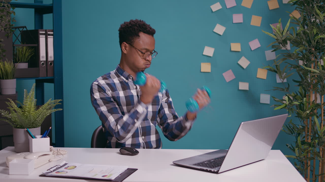 Office worker exercising with dumbbells to train muscles