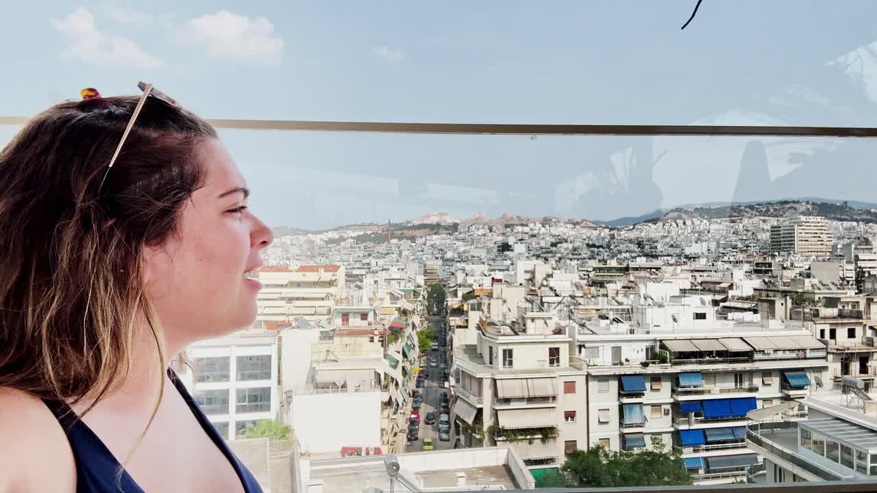 Young Woman in Profile Enjoying the Panoramic City View of Athens from a Rooftop