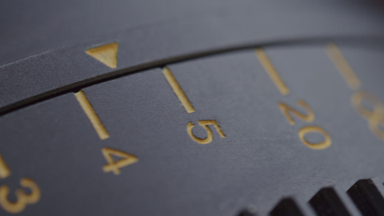 Macro of Aperture Ring Arrow Moving through Engraved Numerical Scale