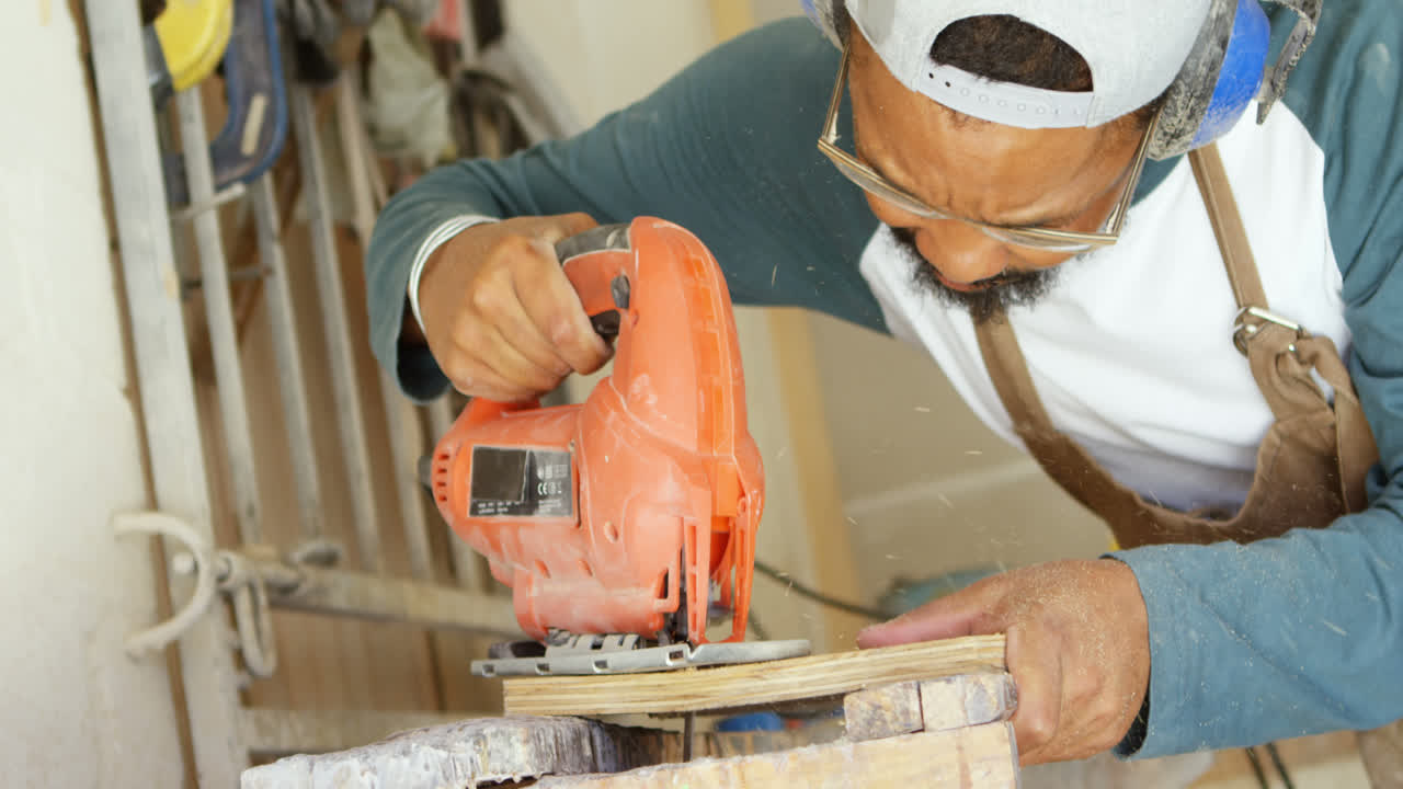 Surfboard maker using machine on wooden plank 4k