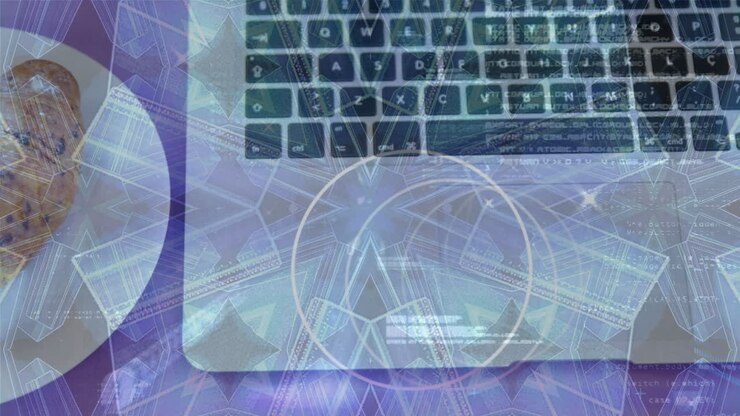 Animation of kaleidoscopic pattern over close up of a laptop and croissant in a plate
