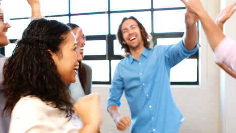 businesspeople giving high five to each other