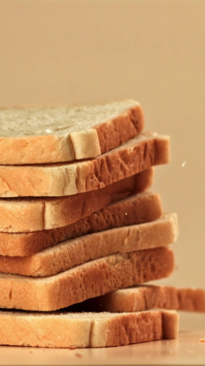 Slow Motion of White Bread Slices Falling and Stacking