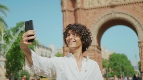 portrait of smiling man taking selfie photo. guy winking for mobile picture.