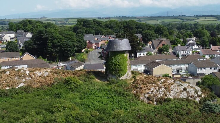 Llangefni hillside windmill ivy covered landmark aerial view overlooking Welsh Snowdonia mountains, Anglesey