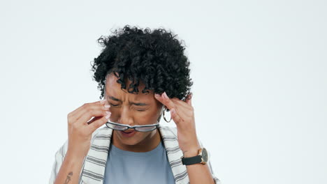 woman, headache and stress with glasses in studio