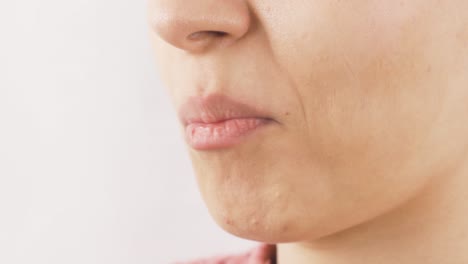 close-up of woman eating sunflower seeds.