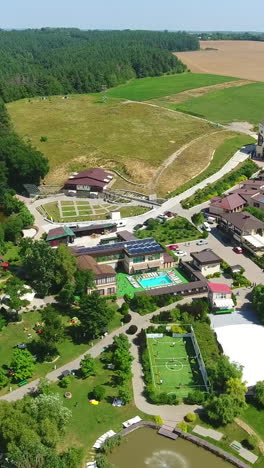 recreational spa resort situated in the rural territory. beautiful area for relax and fun at the backdrop of farmlands. aerial view. vertical video