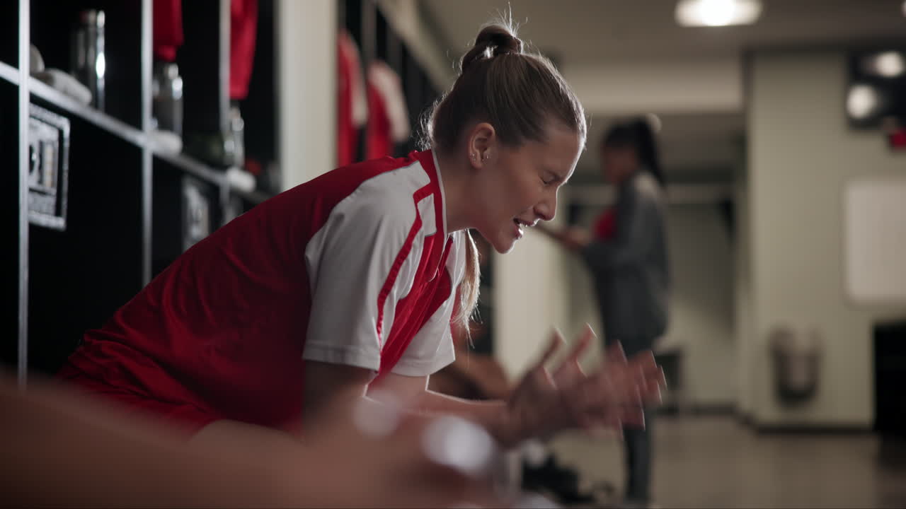Upset Female Athlete in Locker Room