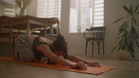 woman practicing yoga at home