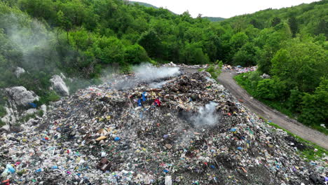 aerial view of a garbage dump that is burning in places